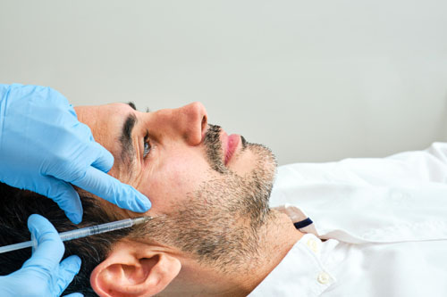 lose-up of a male patient receiving a facial treatment at Dr. Jeffrey Roth's clinic in Las Vegas.